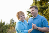 happy retired couple dancing to enhance sexual intimacy